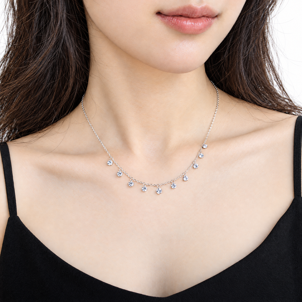 The Astrid CZ Link Necklace — silver-tone CZ charm necklace, alternate worn front view in white studio; reference-based AI visualization.