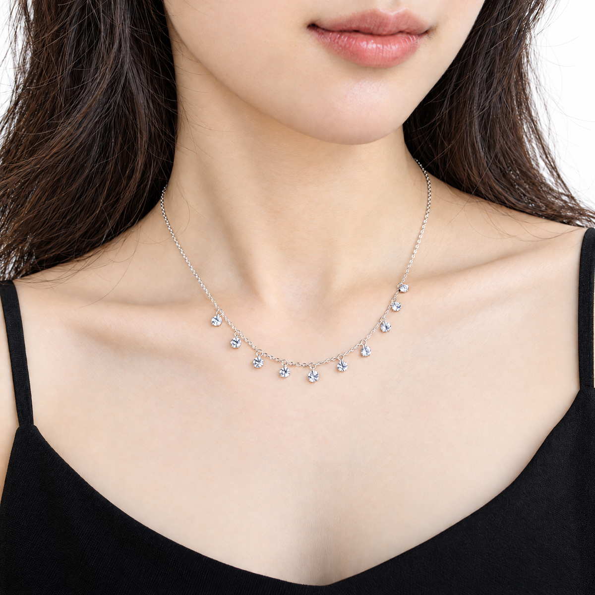 The Astrid CZ Link Necklace — silver-tone CZ charm necklace, alternate worn front view in white studio; reference-based AI visualization.