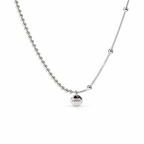 Sterling Silver Eira necklace with round LUCKY medallion, beaded and smooth chain sections, in the existing cropped tabletop view with white studio treatment and soft shadow; AI studio edit and enhancement of the existing supplier source view; chain ends extend beyond the frame.