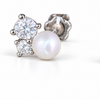 Macro detail crop of one sterling silver pearl and moissanite stud earring on a white studio background.