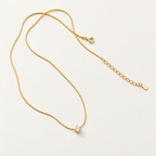 The Elora CZ Pendant — full chain and closure flat lay; reference-based AI visualization