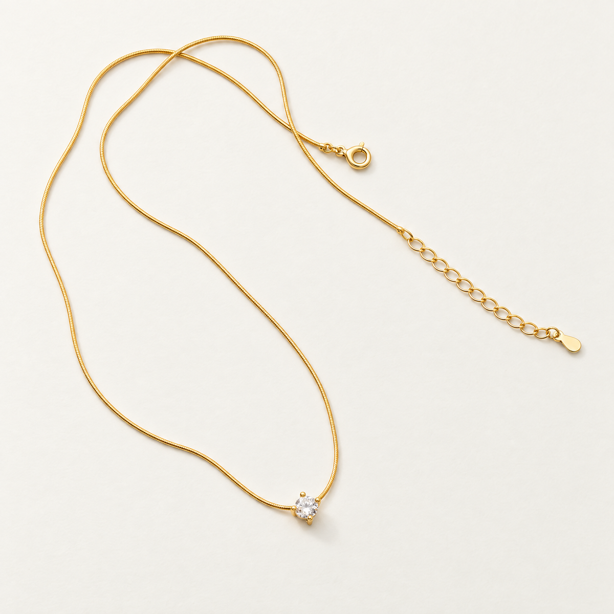 The Elora CZ Pendant — full chain and closure flat lay; reference-based AI visualization