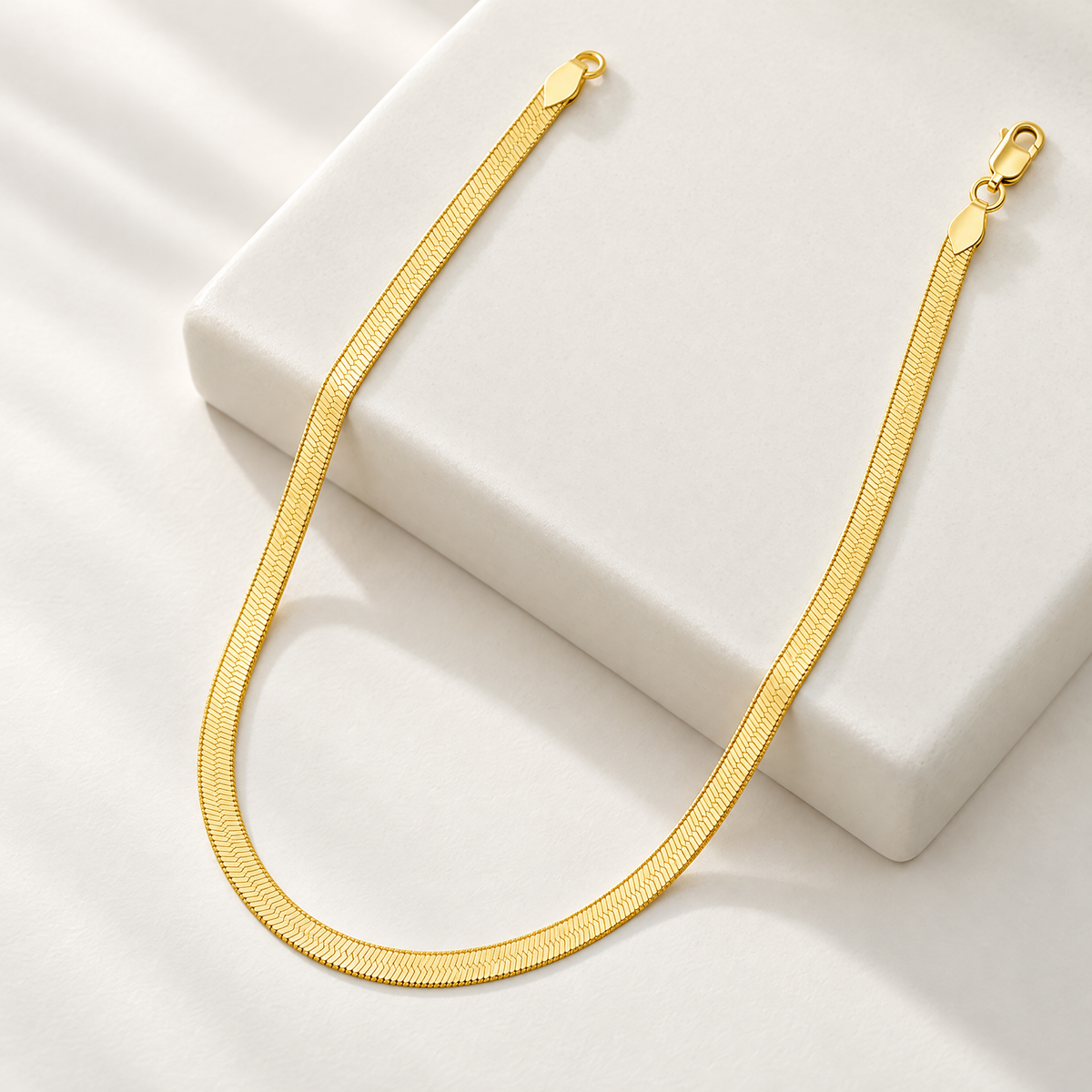 The Nova Herringbone Chain — Ceramic-block angled full-necklace view; reference-based AI visualization