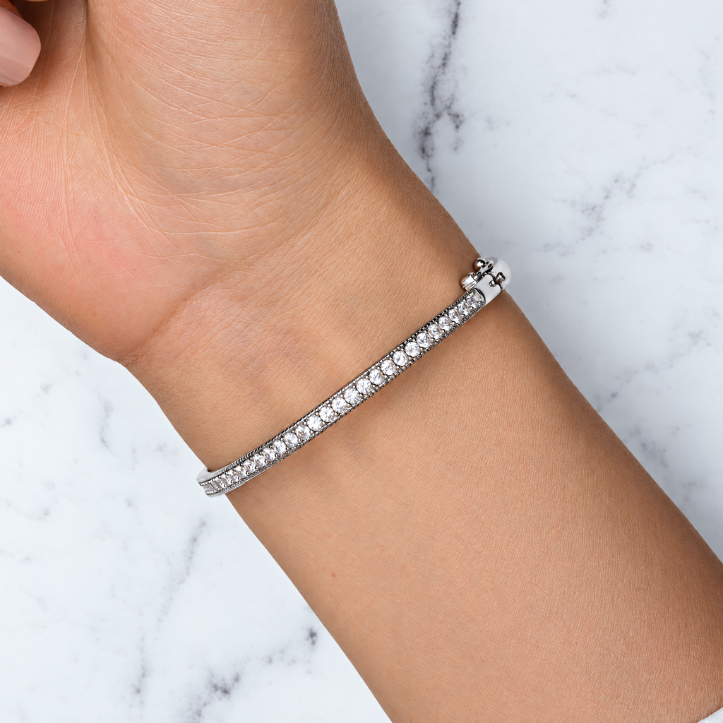 The Maia Pavé Hinge Bangle in Sterling Silver worn on the wrist in the supplier’s clasp-side view, showing the pavé-set cubic zirconia line and hinge clasp.