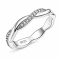 The Veda CZ Twisted Band — primary angled white-studio view with soft shadow; studio-white edit and AI enhancement of the inherited AI-enhanced supplier view, not independently photographed jewelry.
