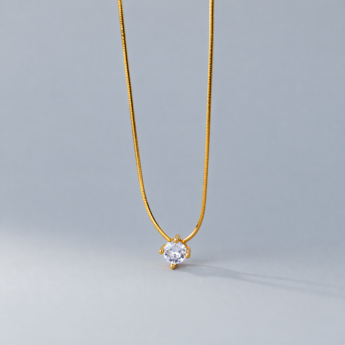 The Halcyon Round CZ Pendant — genuine gold front studio supplier view; AI-enhanced supplier view