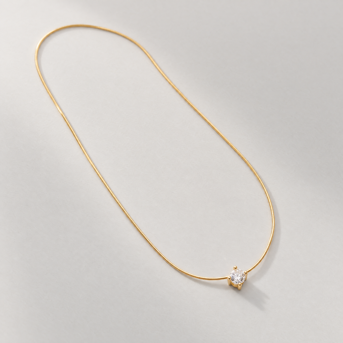 The Elora CZ Pendant — clean diagonal tabletop view; reference-based AI visualization