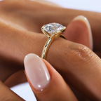 Astrea gold-tone moissanite solitaire ring — on-hand close view; AI-enhanced supplier view