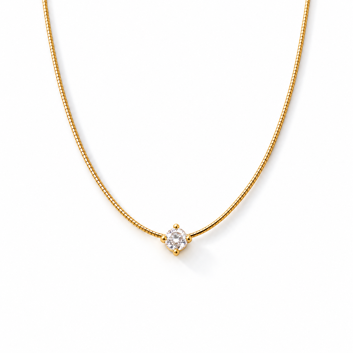 The Halcyon Round CZ Pendant — gold pendant on a white studio surface with a subtle natural shadow; reference-based AI visualization.