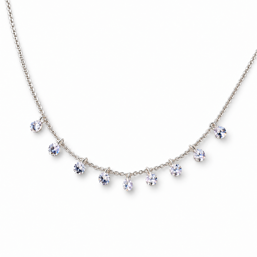 The Astrid CZ Link Necklace — silver-tone CZ charm necklace, tabletop front view in white studio; reference-based AI visualization.