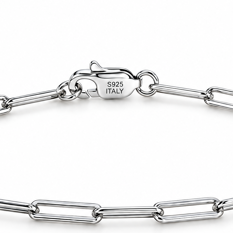 Sterling silver paperclip bracelet clasp detail with visible S925 ITALY hallmark on a white studio background.