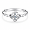 Clean white studio macro derivative of the four-lobed quatrefoil moissanite ring, preserving the front source angle and visible inner-band S925 hallmark.