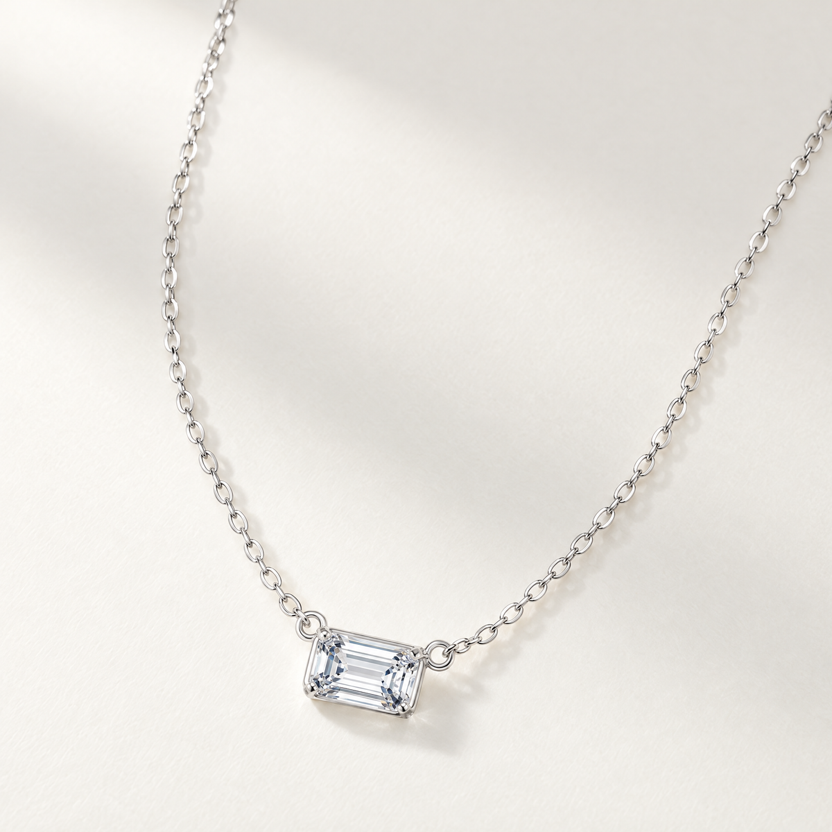 The Mara Geometric CZ Pendant — Asymmetric oblique tabletop necklace; reference-based AI visualization