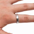 The Lena Hammered Open Band Ring in 925 sterling silver, worn view with white-studio lighting.