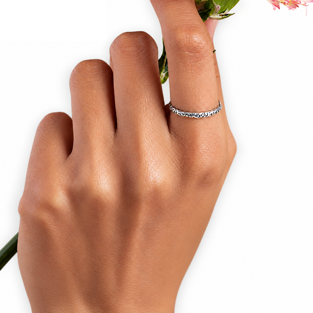 Worn view of the Sterling Silver engraved scroll band on a hand.