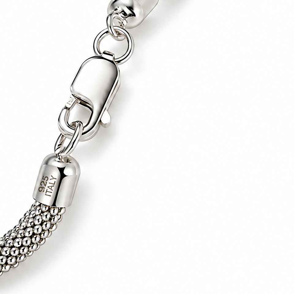 Clasp and woven mesh detail crop of The Liva Mesh Chain Bracelet on a white studio background.